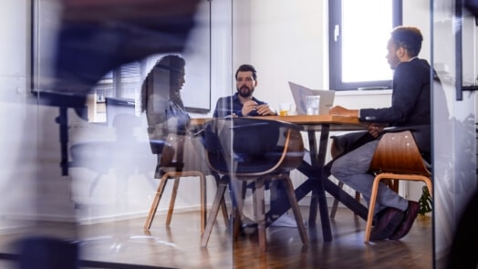 Four IT workers in an office setting