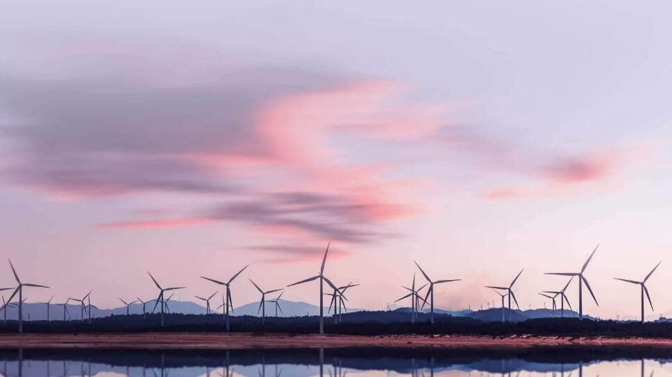 Wind turbine farm with a lake and hills