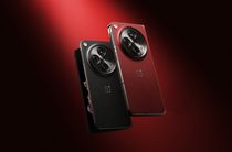 The OnePlus Open Apex Edition in Crimson Shadow and Voyager Black against a red background.