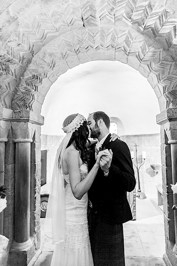 Happy married couple kisses during the wedding ceremony at Edinburgh Castle