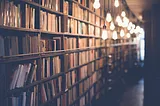 Photo of shelves upon shelves of books down a long corridor