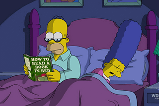 Homer Simpson reading a book.