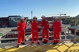 4 men in security equipment in Egersund Yard in Norway, smiling at the Camera.