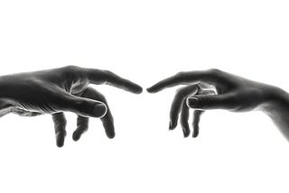 Two index fingers attempting to touch each other