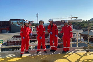 4 men in security equipment in Egersund Yard in Norway, smiling at the Camera.