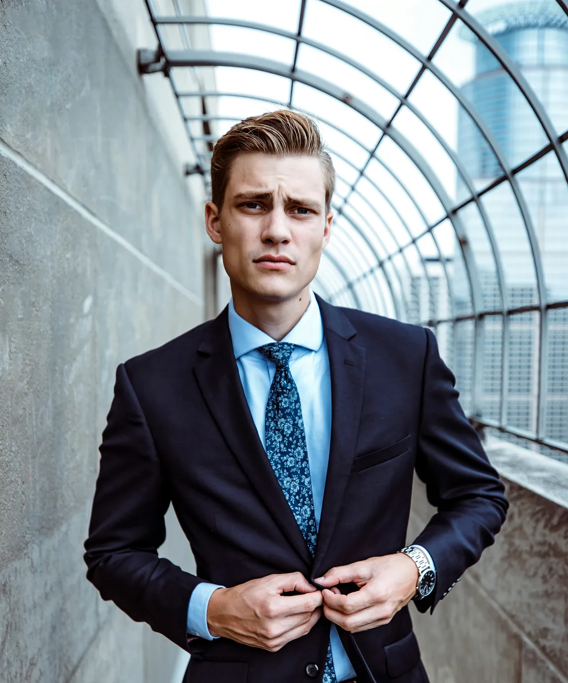 An Expert Businessman Buttoning Suit on a Walkway, Looking Confident | Photo by Gregory Hayes on Unsplash