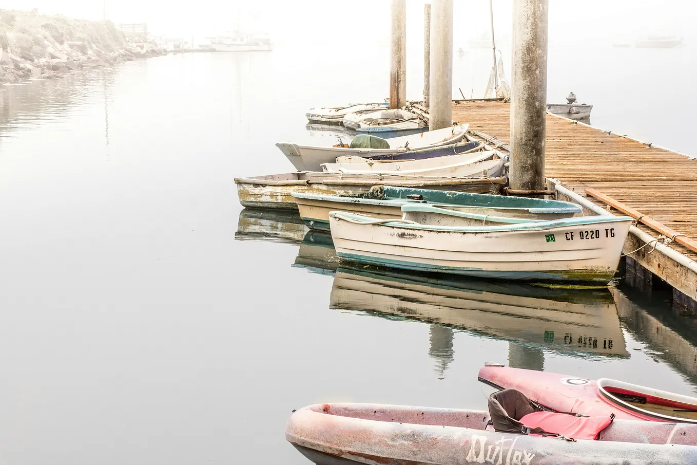 white boats against a whitish dock and still water