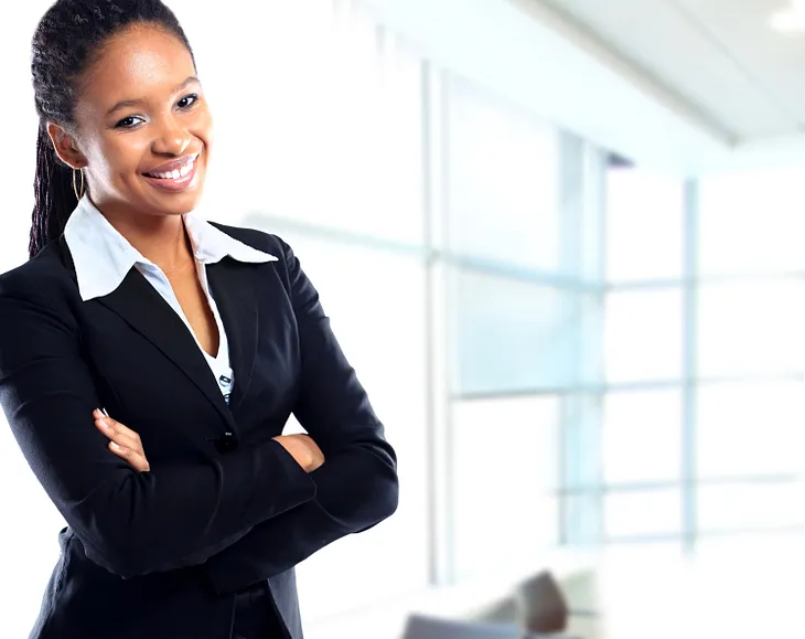 A young black business woman standing with folded arms