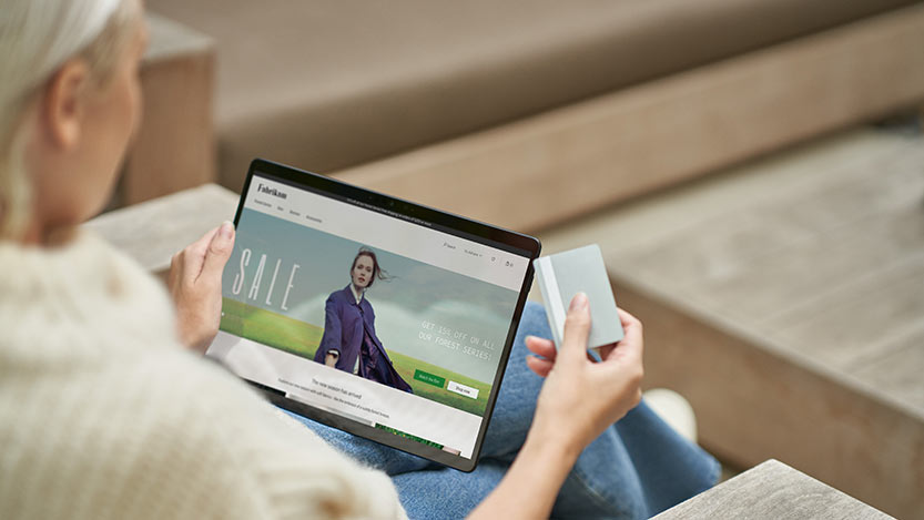 A woman seen using her card to buy items online.