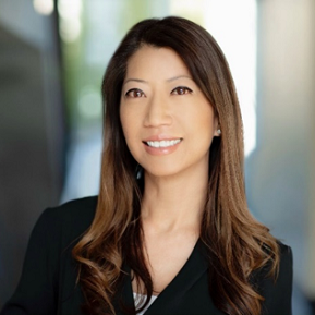 Author headshot of a woman smiling at the camera.