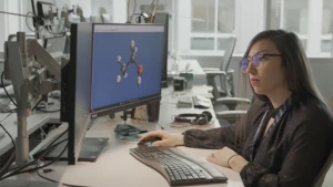 a person sitting at a desk in front of a computer