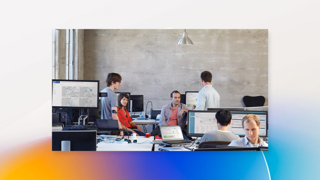 a group of people looking at a computer screen