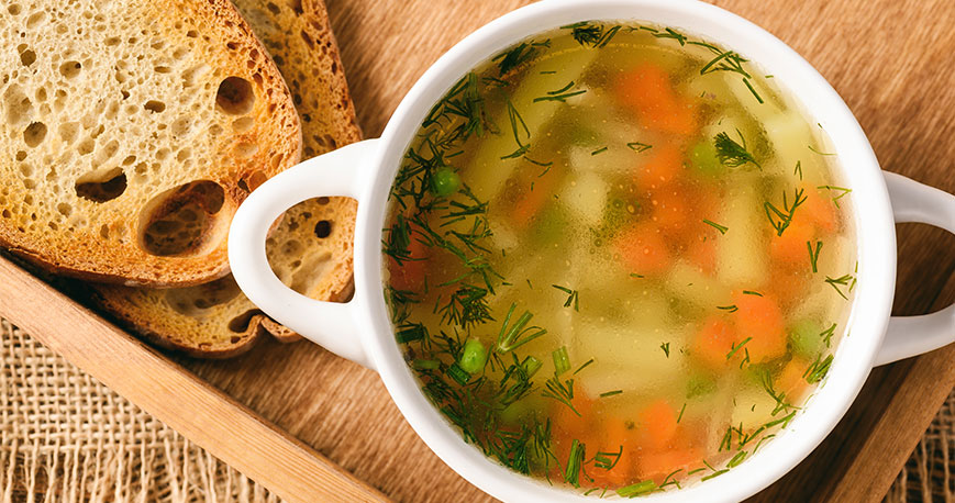 Chicken soup in bowl with bread