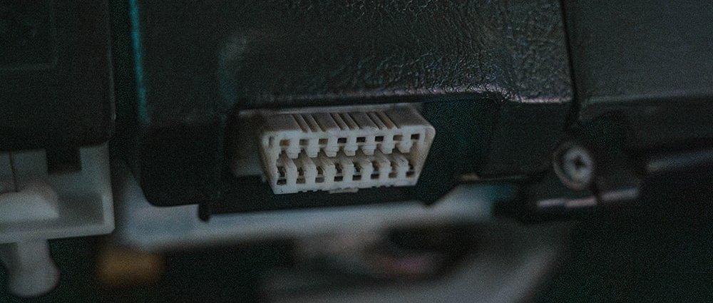  The image shows a close-up of an OBD2 port in Toyota vehicle