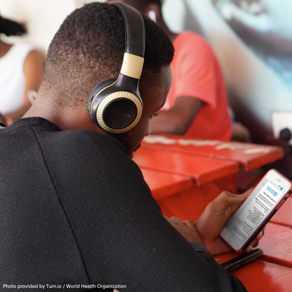 Man with headphones looking at phone