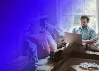 Man sitting down and working at his laptop