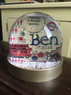 there is a snow globe with the words ben in it on top of a table