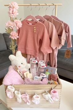 a wooden crate filled with baby items on top of a table