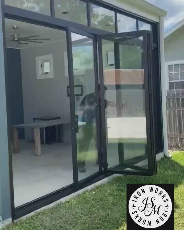 This may contain: an open patio door in front of a house