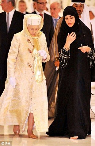 Queen Elizabeth II  walks with a guide in the Sheikh Zayed Grand Mosque in Abu Dhabi, as part of a five-day state visit to the Gulf...