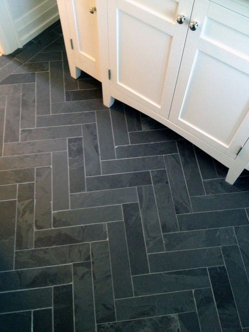 Cutting slate tiles into a herringbone pattern is an inexpensive way to create a high impact pattern.