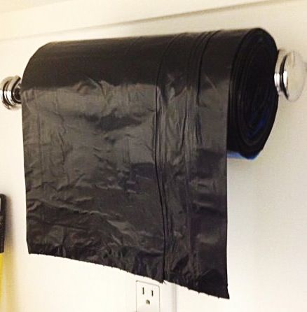 Get ready for all those fall leaves by having your  recyclable trash bags within easy reach on a repurposed towel rack.