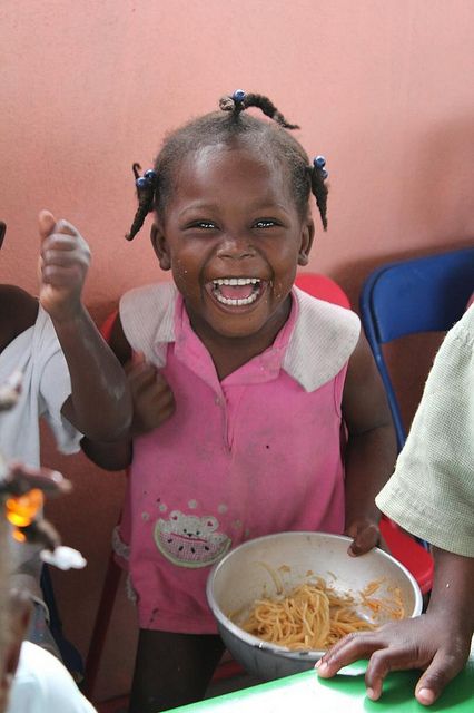 Big smiles from a little girl in Haiti as she's served pasta for lunch from our Food For Kids program: http://goodneighbors.org/food-for-kids