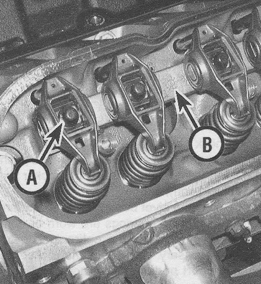 Chevrolet Silverado V8 engines _ Remove the mounting bolts (A) and rocker arms, then remove the pivot support pedestal (B)