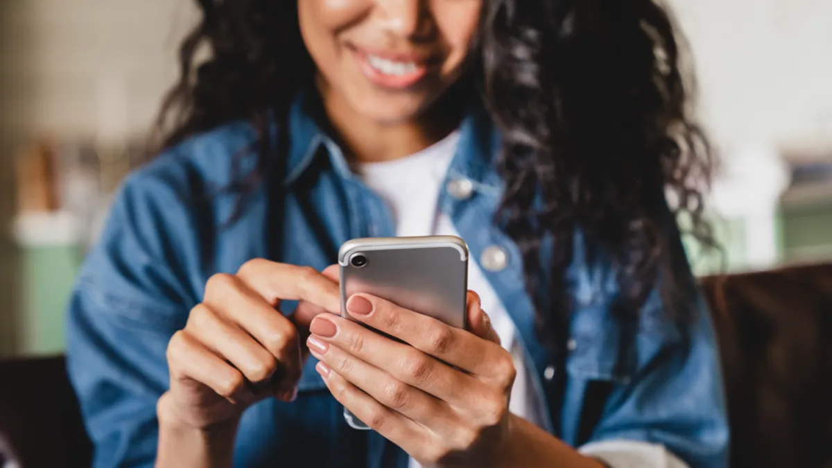 Woman looking at mobile device.