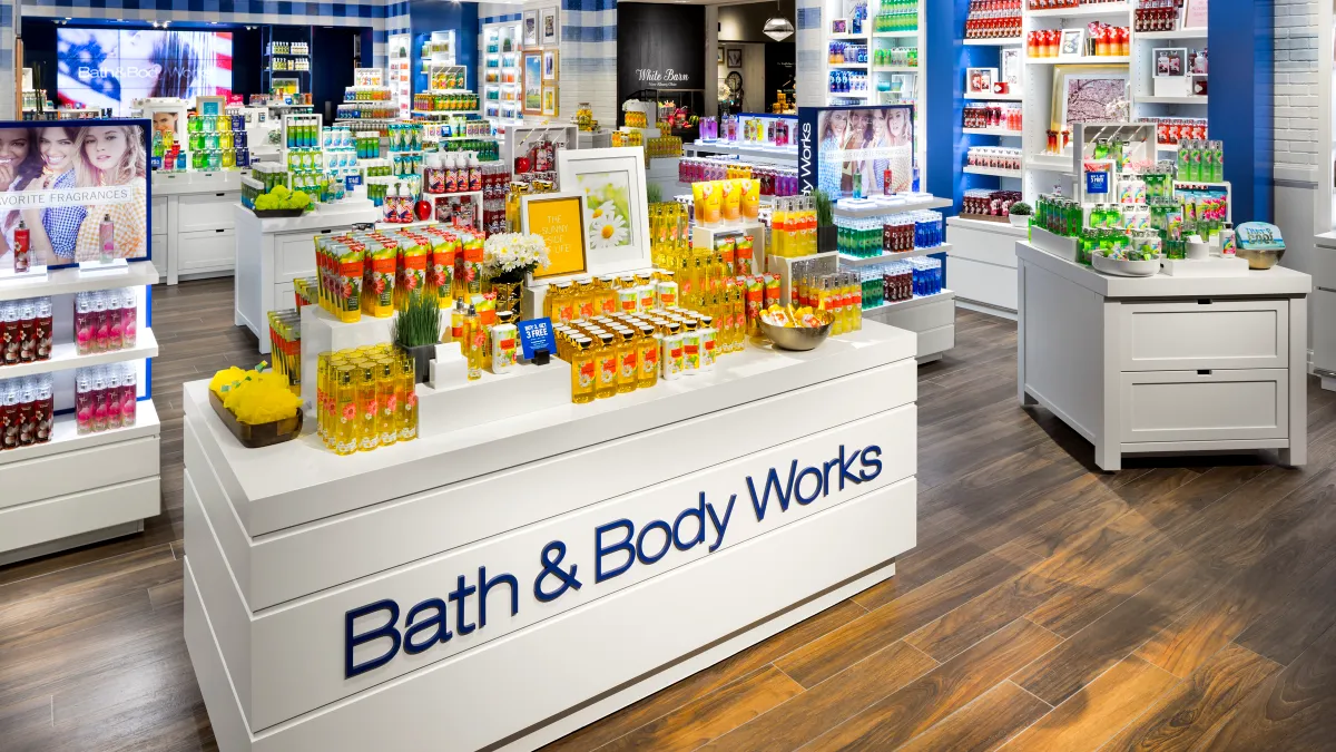 Interior store shot of Bath & Body Works with counters full of products.