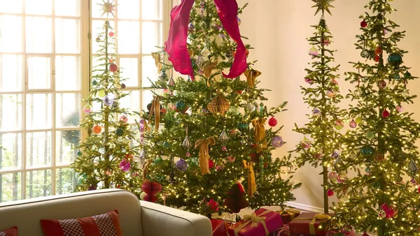 Holiday decorations in a room with a window.