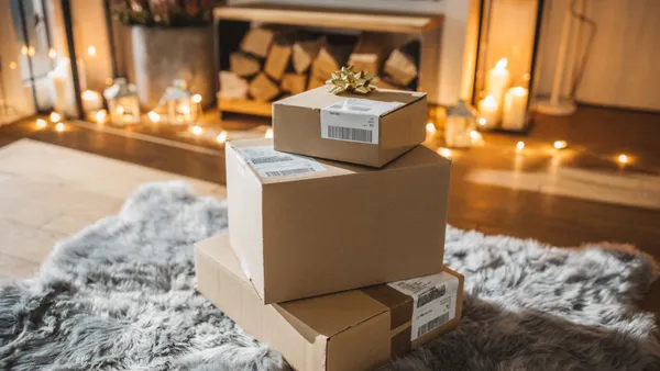 Three boxes stacked with a bow on top in a holiday scene.