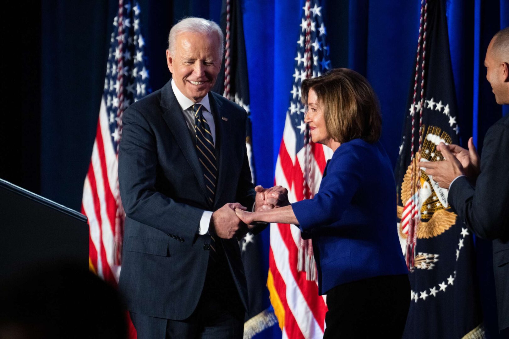 President Joe Biden greets Speaker Nancy Pelosi and Democratic Caucus Chair Hakeem Jeffries, D-N.Y., on Friday before addressing the House Democratic Caucus Issues Conference in Philadelphia. 