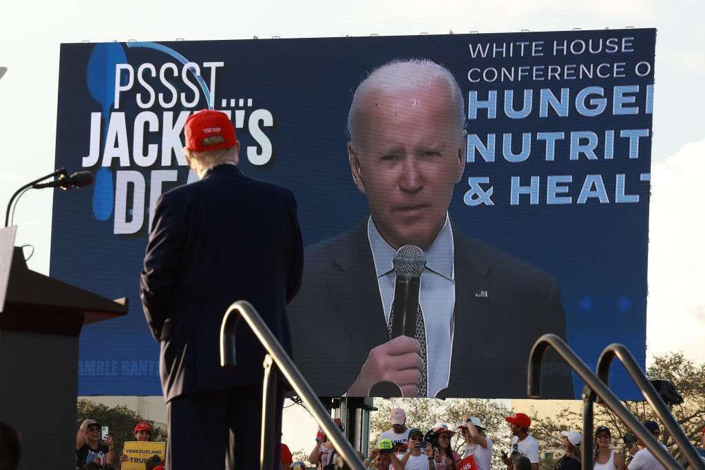 Former President Donald Trump watches a video of President Joe Biden playing during a political rally in November in Florida.