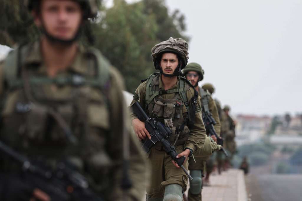 Israeli troops on the ground Wednesday near Sderot, as fighting between Israeli troops and Hamas continues there.