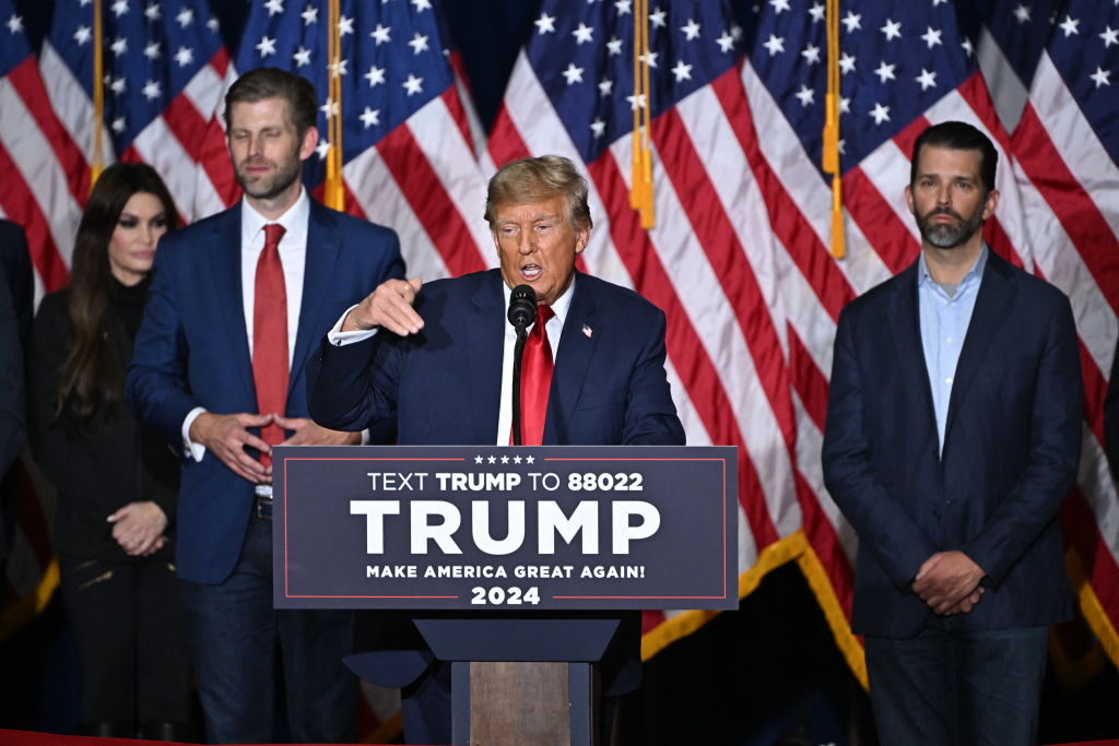 Former President Donald Trump, with sons Eric Trump and Donald Trump Jr., at a watch party during the 2024 Iowa caucuses Monday in Des Moines. (Photo by JIM WATSON/AFP via Getty Images)