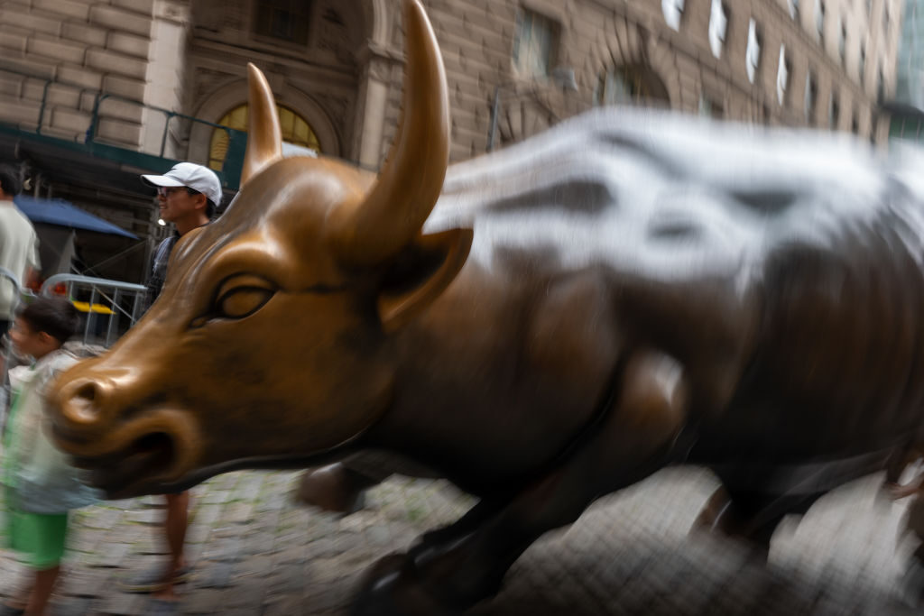 People take pictures of the Wall Street bull in New York City in August. A proposal that advanced out of a Senate committee this summer would curb stock trading among members of Congress, but some fear it won’t see further movement.