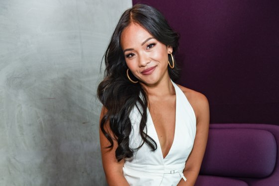 Jenn Tran sits and smiles for a portrait