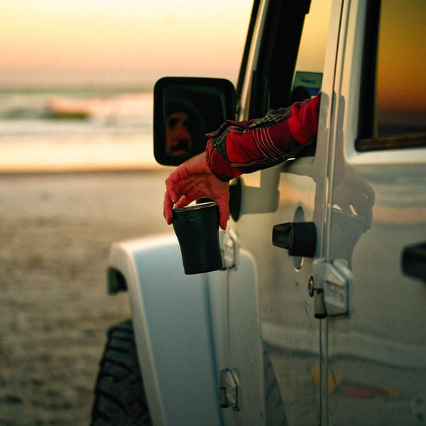 Man in Jeep at beach holding a 12 oz. Matte Black Tumbler