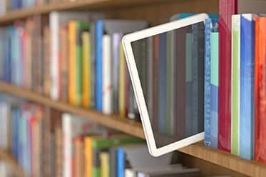 tablet on bookshelf