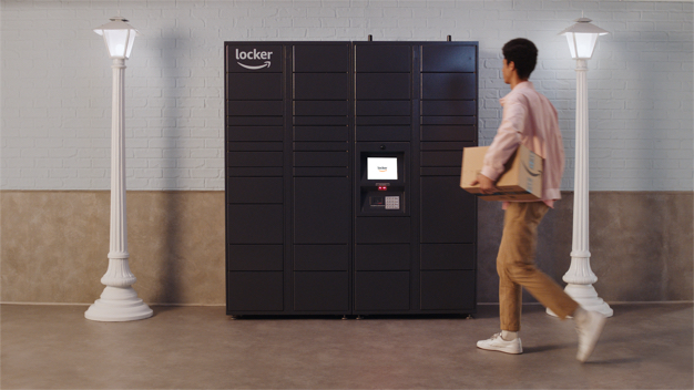 Man carrying package to gray Amazon Hub Apartment Locker.