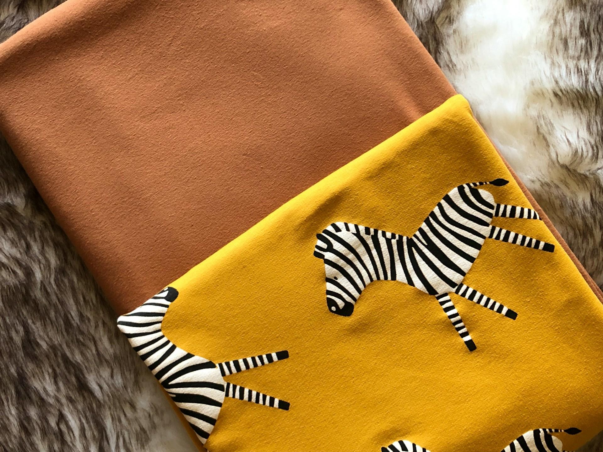 A closeup of a fabric with a zebra pattern on it.