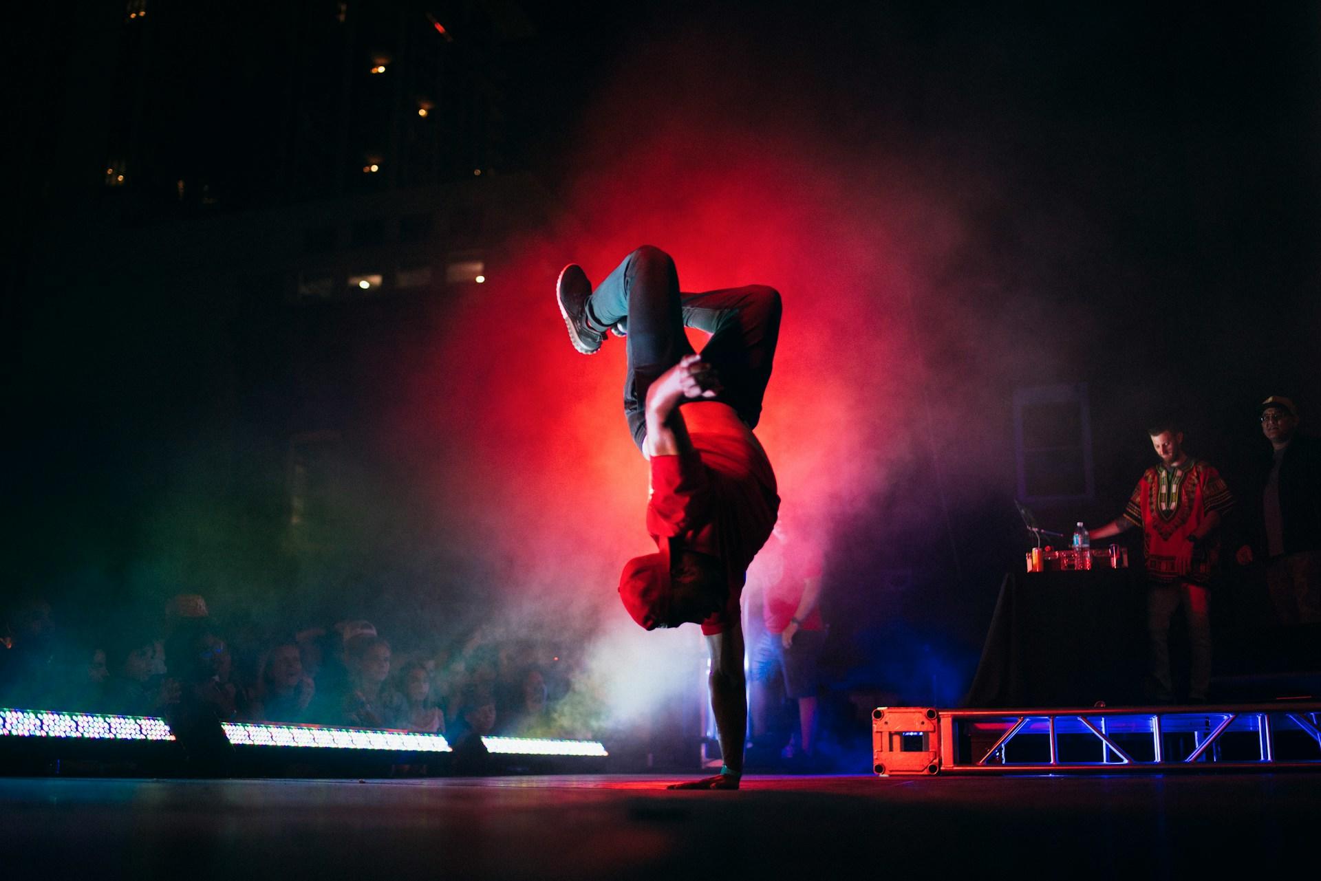 A man doing breakdancing on a stage.