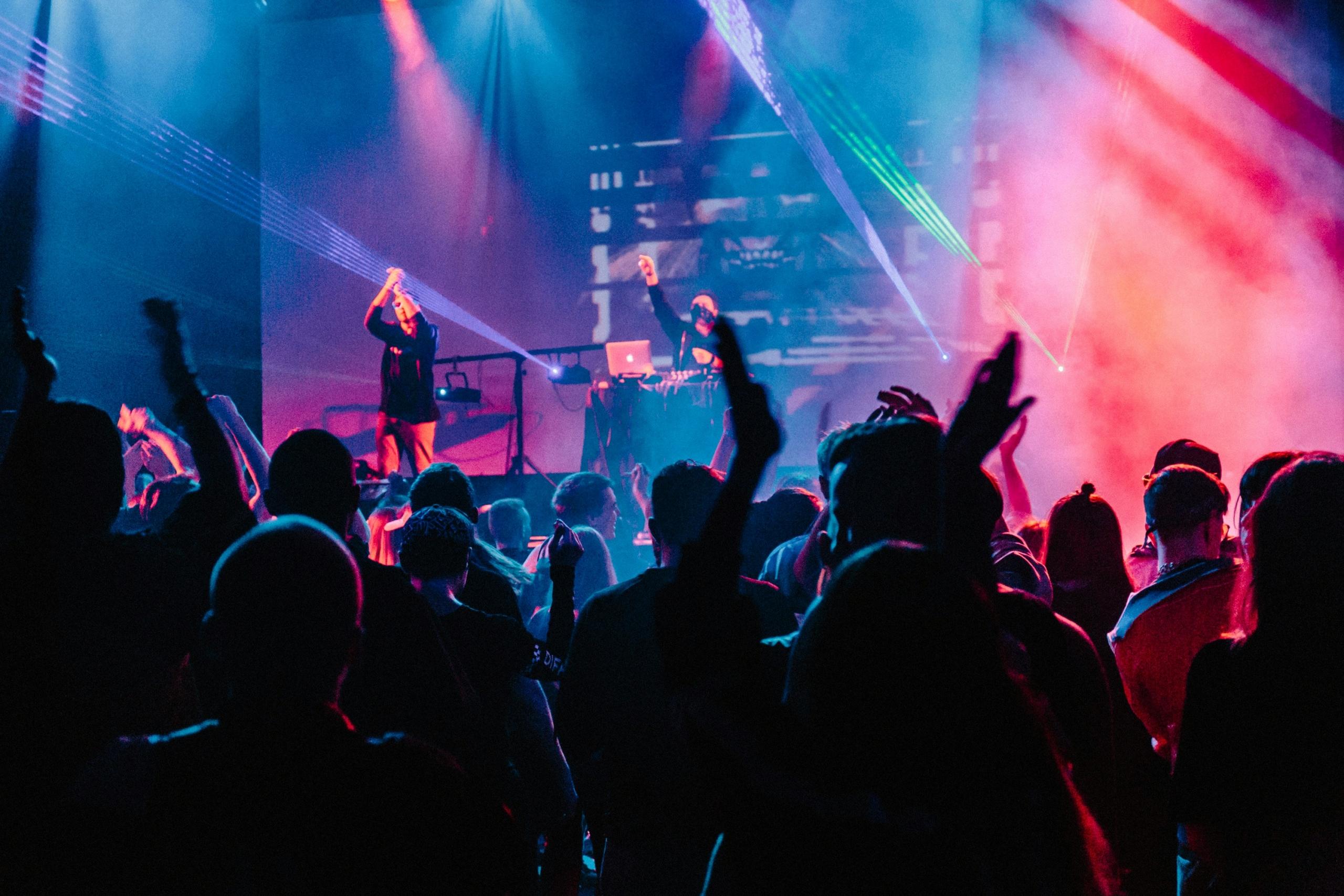 evening concert with a musician and crowd dancing