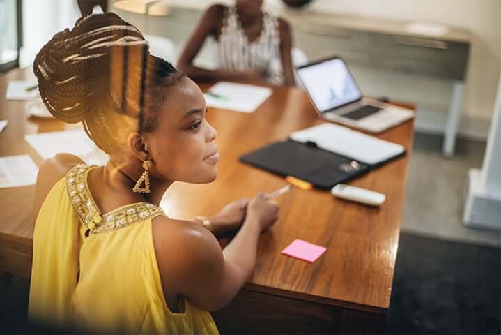 young black female employee sitting at a conference table