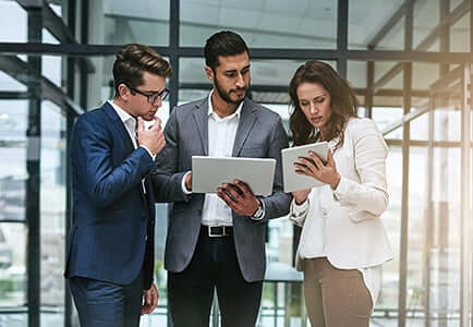 employees looking at paperwork and discussing ideas