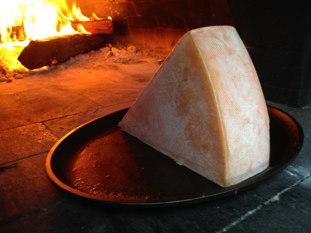 raclette cheese melting in wood fired oven