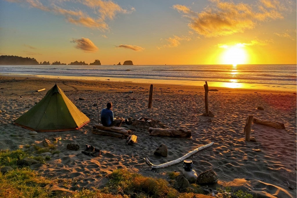 a man camping on the beach