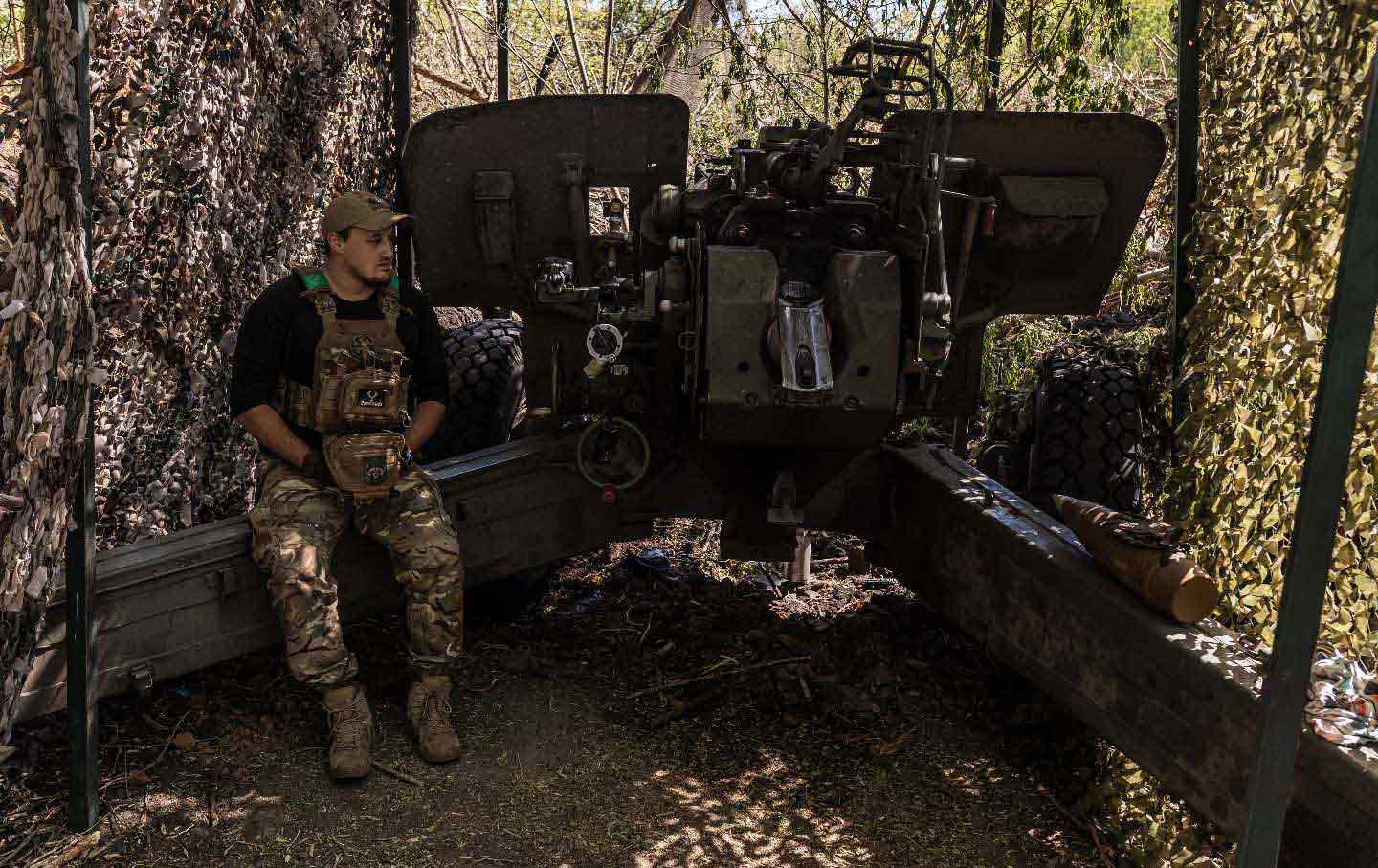 A Ukrainian soldier waits for orders next to the artillery at his fighting position as the Russia-Ukraine war continues in the direction of Liman, Ukraine, on May 25, 2024.