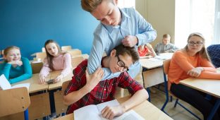 education, bullying, violence, aggression and people concept - student boy suffering of classmate mockery